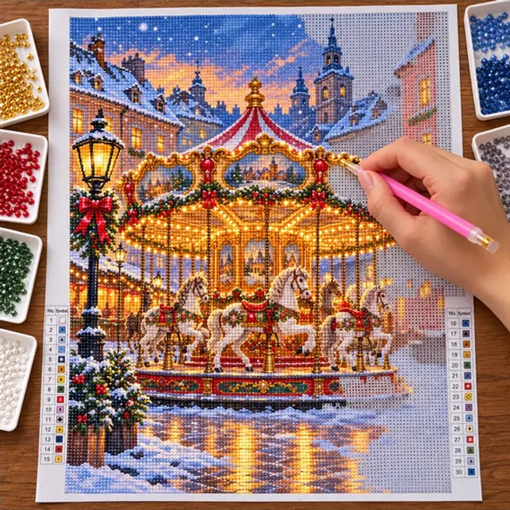 Diamond painting process showing a golden carousel with white horses glowing in a snowy holiday village being completed with a stylus