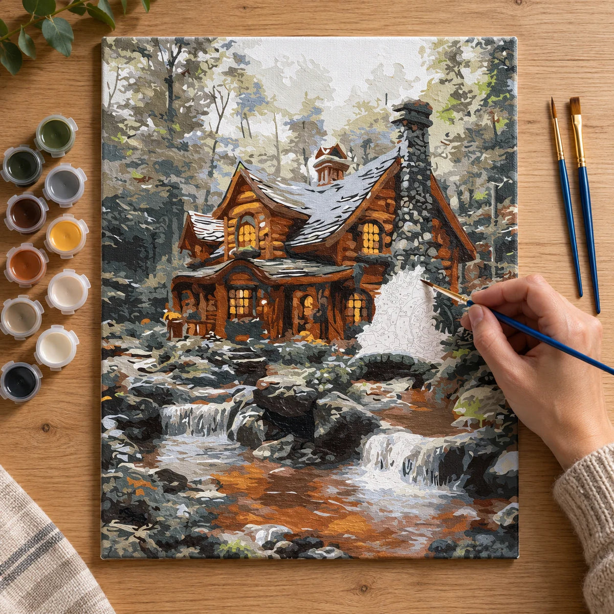 Complete Winter Log Cabin by Stream numbered canvas being painted with acrylic paints and brushes