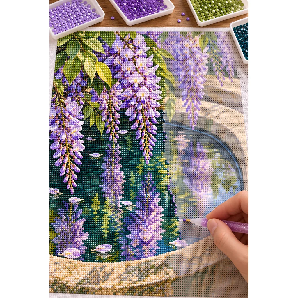 Lavender wisteria and green leaves reflected in a stone basin: diamond painting in progress with a pen