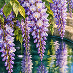 Lavender wisteria and green leaves reflected in a stone basin: close-up of the diamond drills