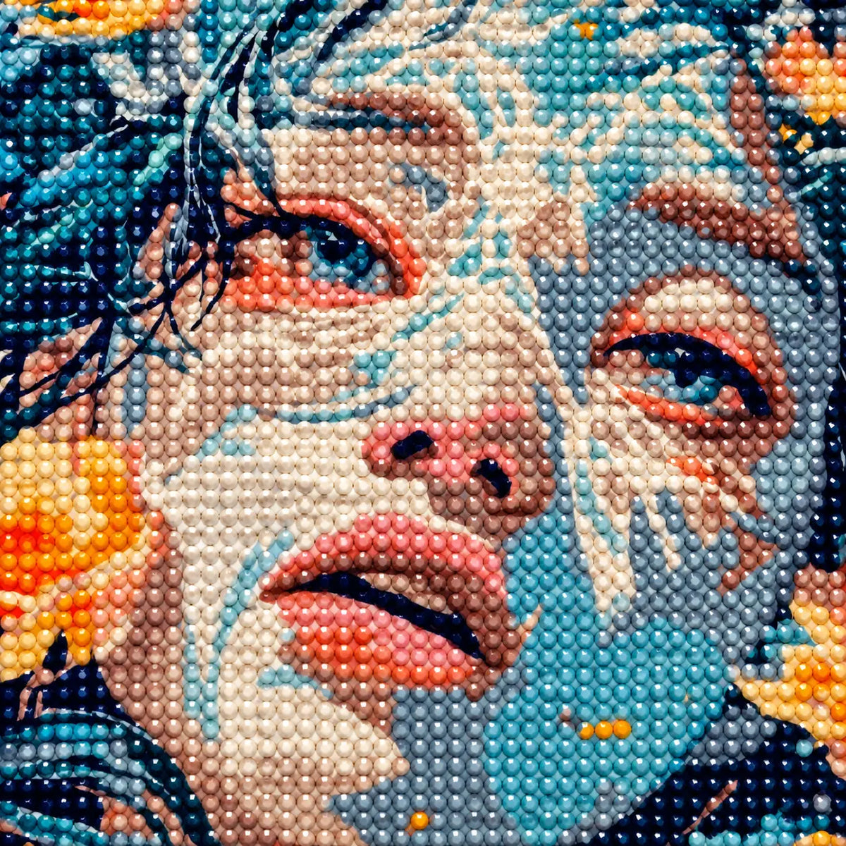 Close-up of diamond drills on artwork showing a woman’s portrait surrounded by golden and blue flowers.