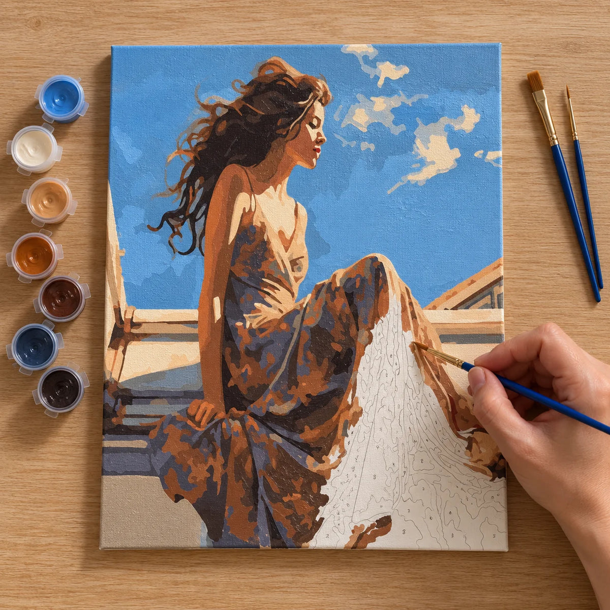 Complete Woman in Flowing Dress by the Sea numbered canvas being painted with acrylic paints and brushes